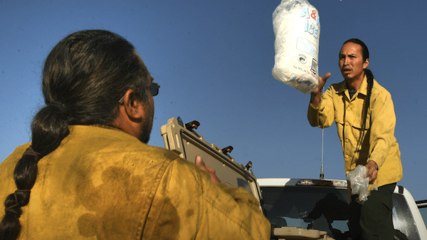  | Rosebud Sioux firefighter Chance Wooden Knife throws a bag of ice to firefighter Smokey Kills Smart at camp as their crew gets ready to head out on the Spring Creek Fire in 2018 in La Veta Colorado Helen H RichardsonThe Denver Post via Getty Images | MR Online